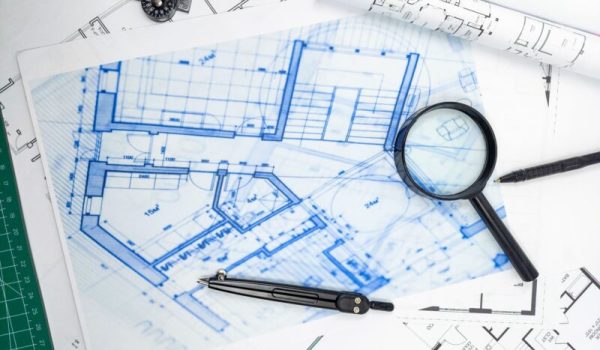 vecteezy_hands-of-engineer-working-on-blueprint-architecture_25037335-min-aspect-ratio-800-500